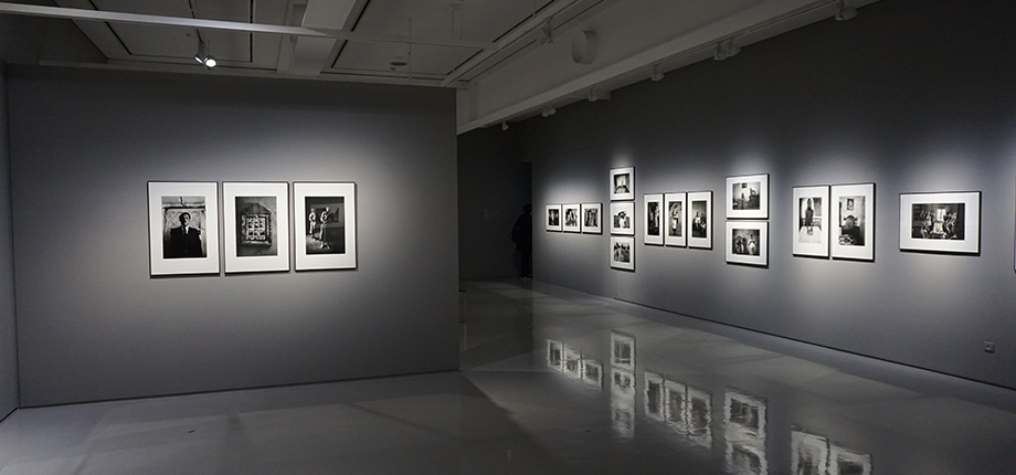 Photo of an art gallery showing several black and white photos on the walls