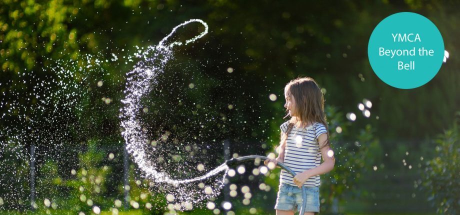 Child playing with water hose